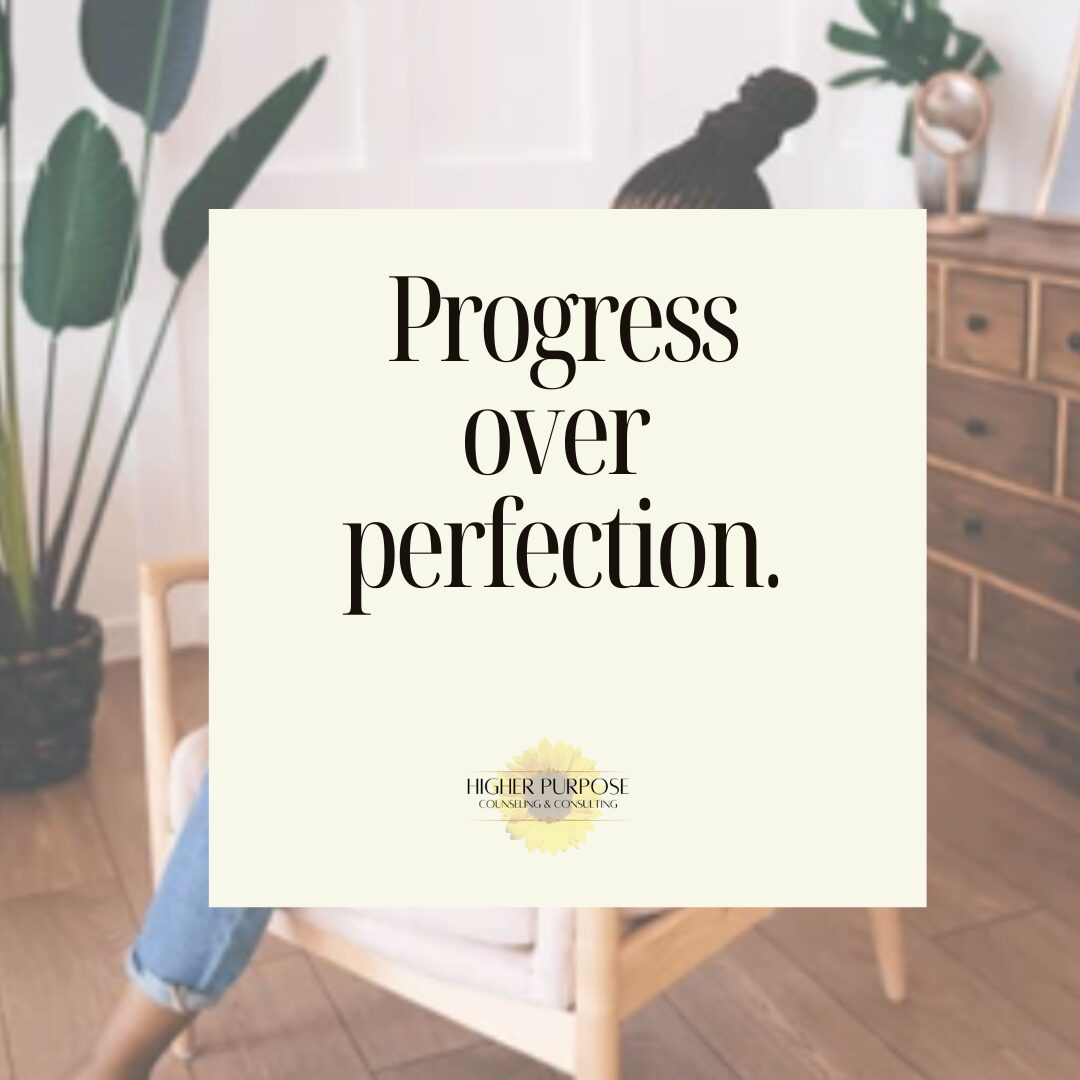 A quote on a white background reads 'Progress over perfection' in a room with plants and wooden furniture.