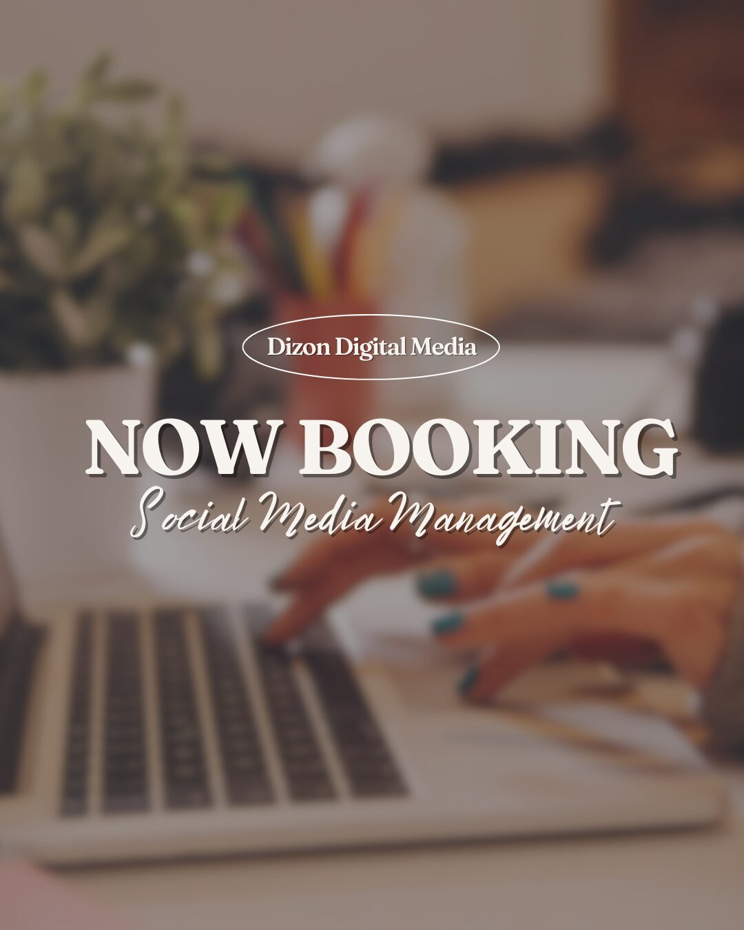 Hands typing on a laptop keyboard with blurred background of a desk and plant.