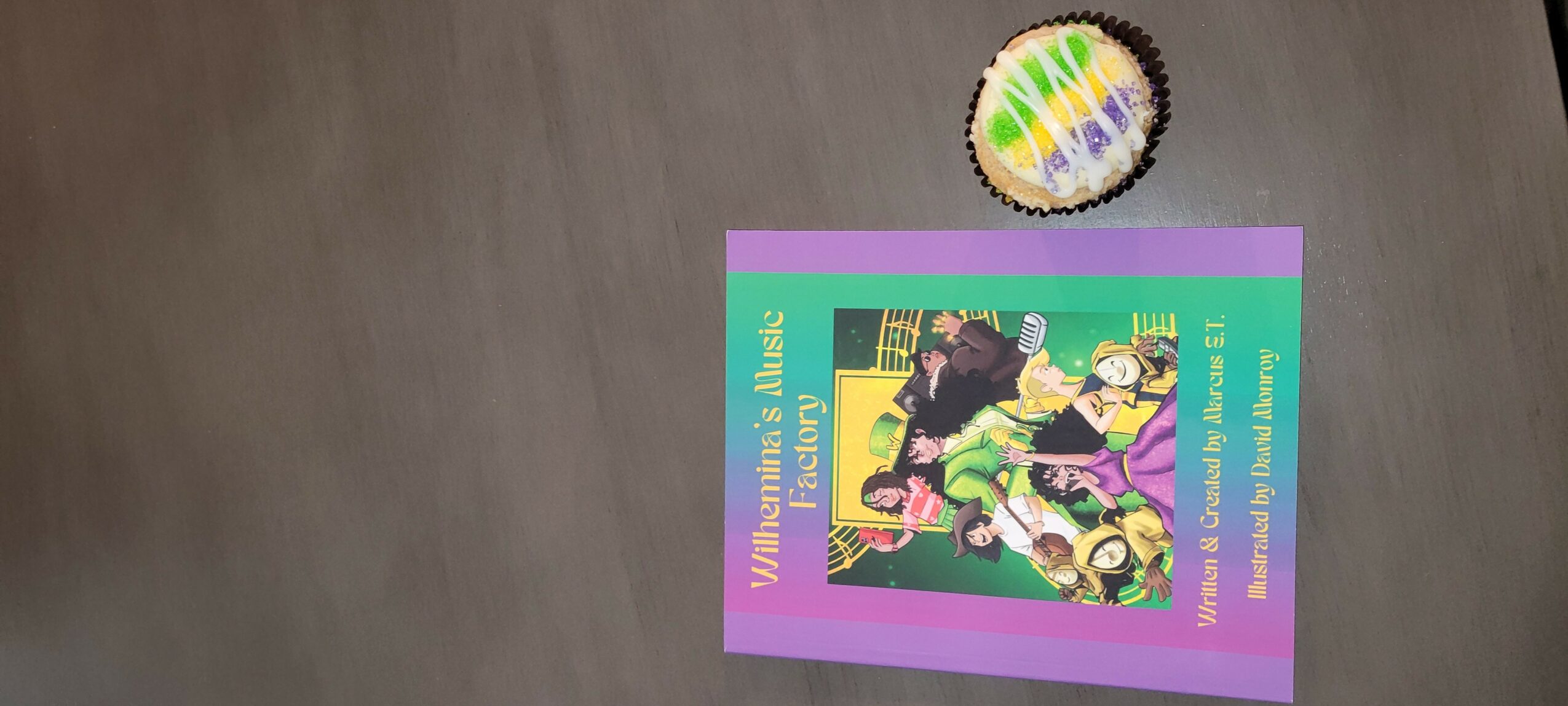 Colorful booklet with cartoon characters and a circular badge on a wooden surface.