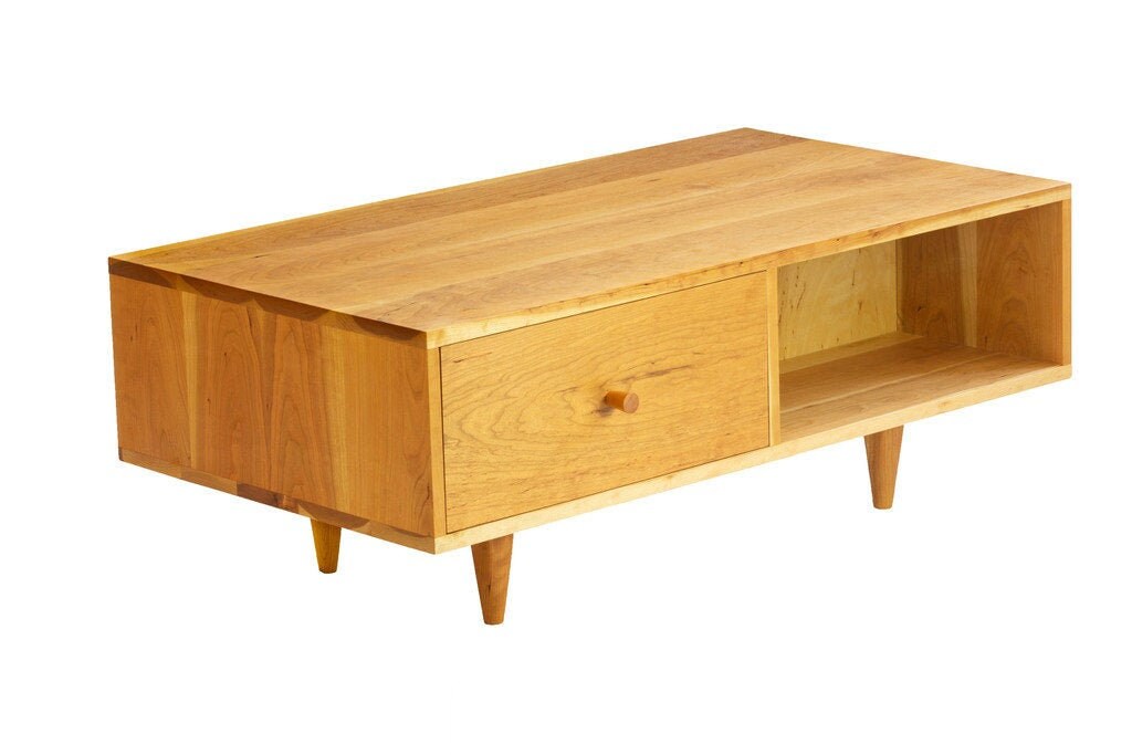 Wooden TV stand with open shelf and drawer, four angled legs, on a white background.