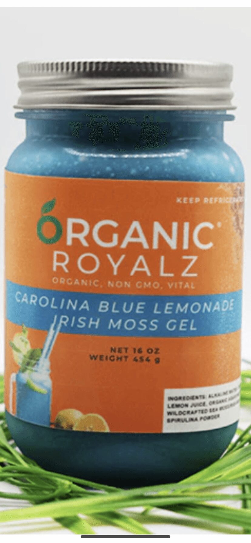 Jar of organic Carolina blue lemonade Irish moss gel with label, surrounded by green grass, on a white background.