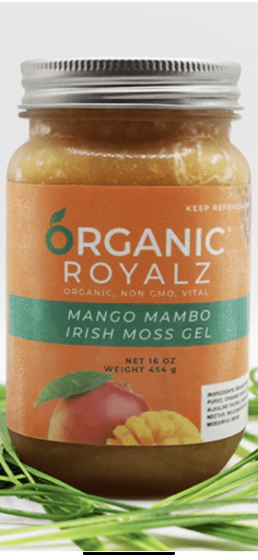 Jar of organic mango mambo Irish moss gel with label, lid, and green grass at base, on a white background.