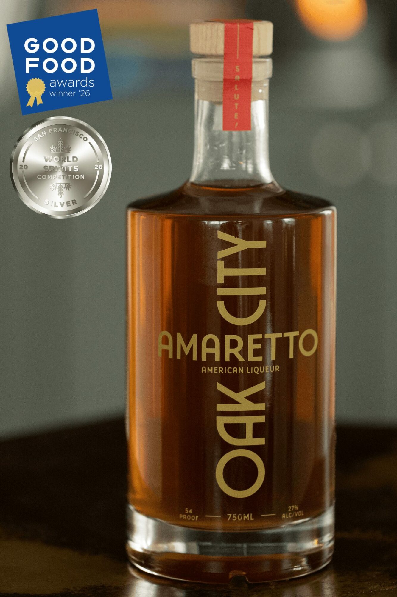 Bottle of Amaretto liqueur with a red and beige cap, label reading 'Oak City,' against a blurred background.