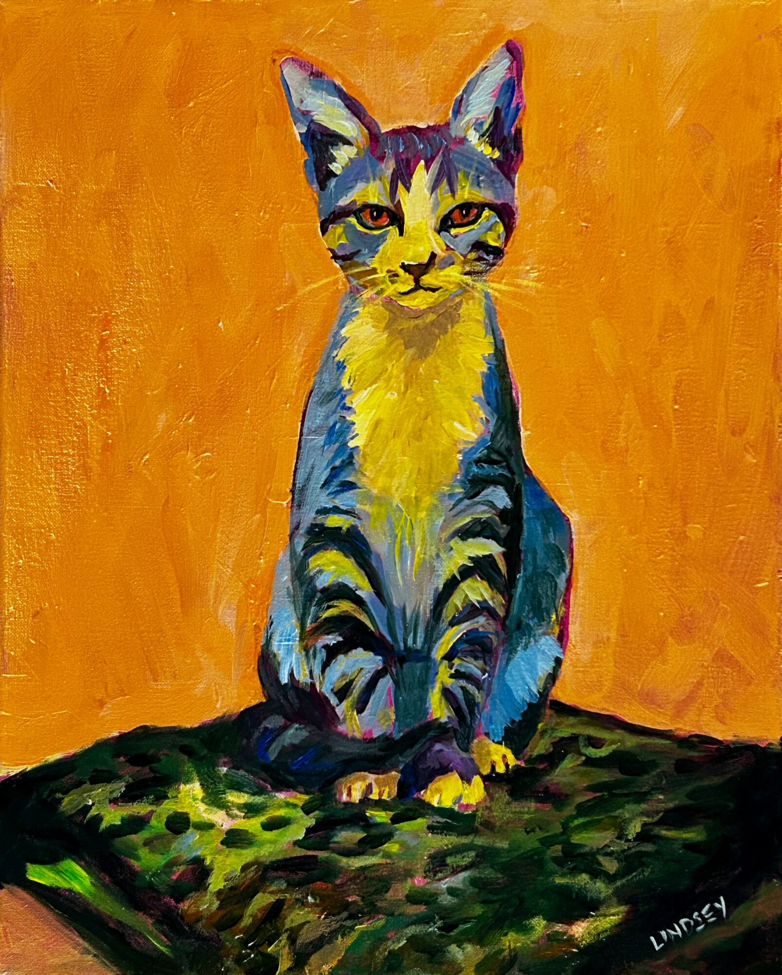 Colorful painting of a sitting cat with yellow eyes against an orange background, on a green surface.