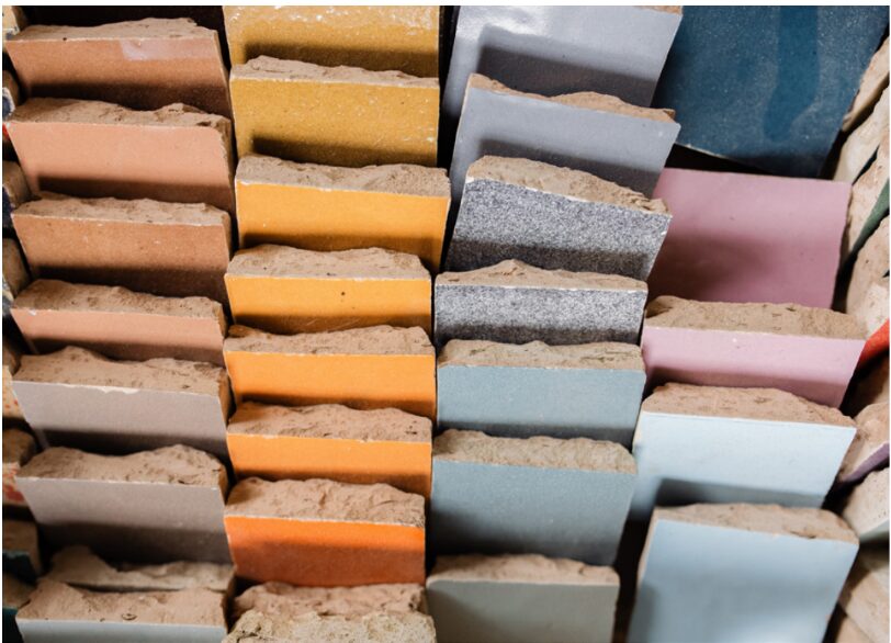 Colorful stacked soap bars in various shades, arranged vertically in a display. Word count: 20