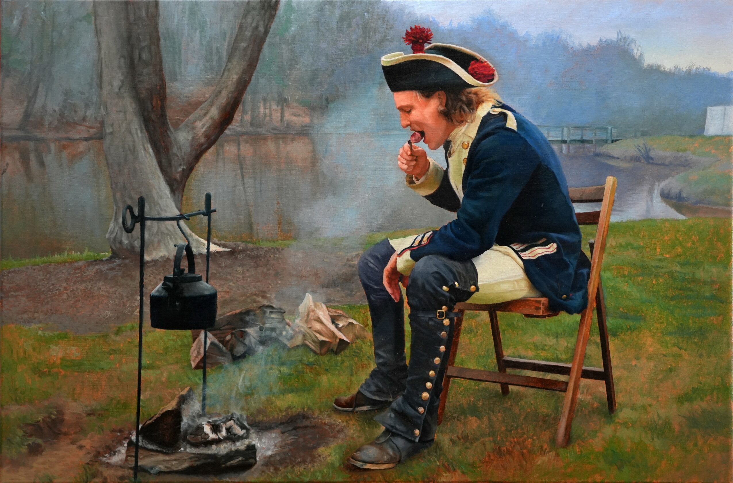 A person dressed as a historical figure sits on a wooden chair outdoors, smoking a pipe near a small fire with a kettle.