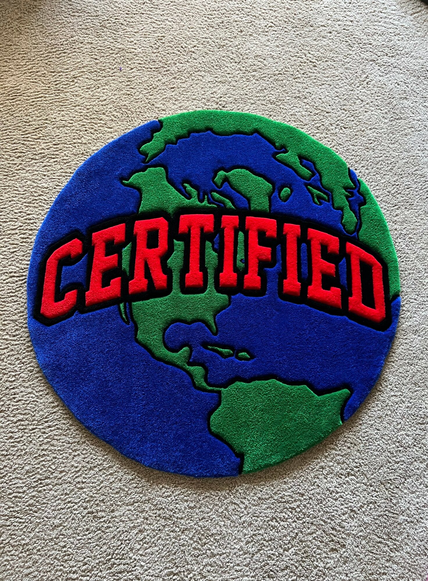 Round patch with a globe showing North and South America, and the word CERTIFIED in red across the center.