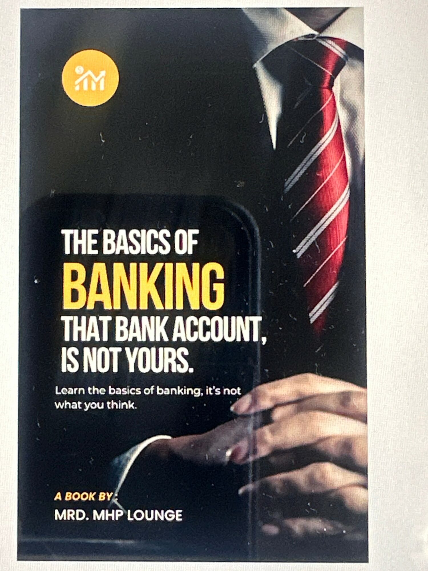 Book cover titled 'The Basics of Banking' with a person in a suit and red striped tie holding a pen.