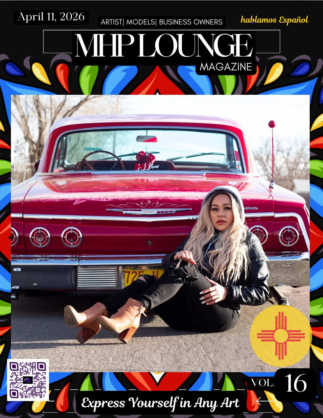 Woman with long blonde hair sitting on ground in front of a red vintage car, wearing black leather jacket and pants.