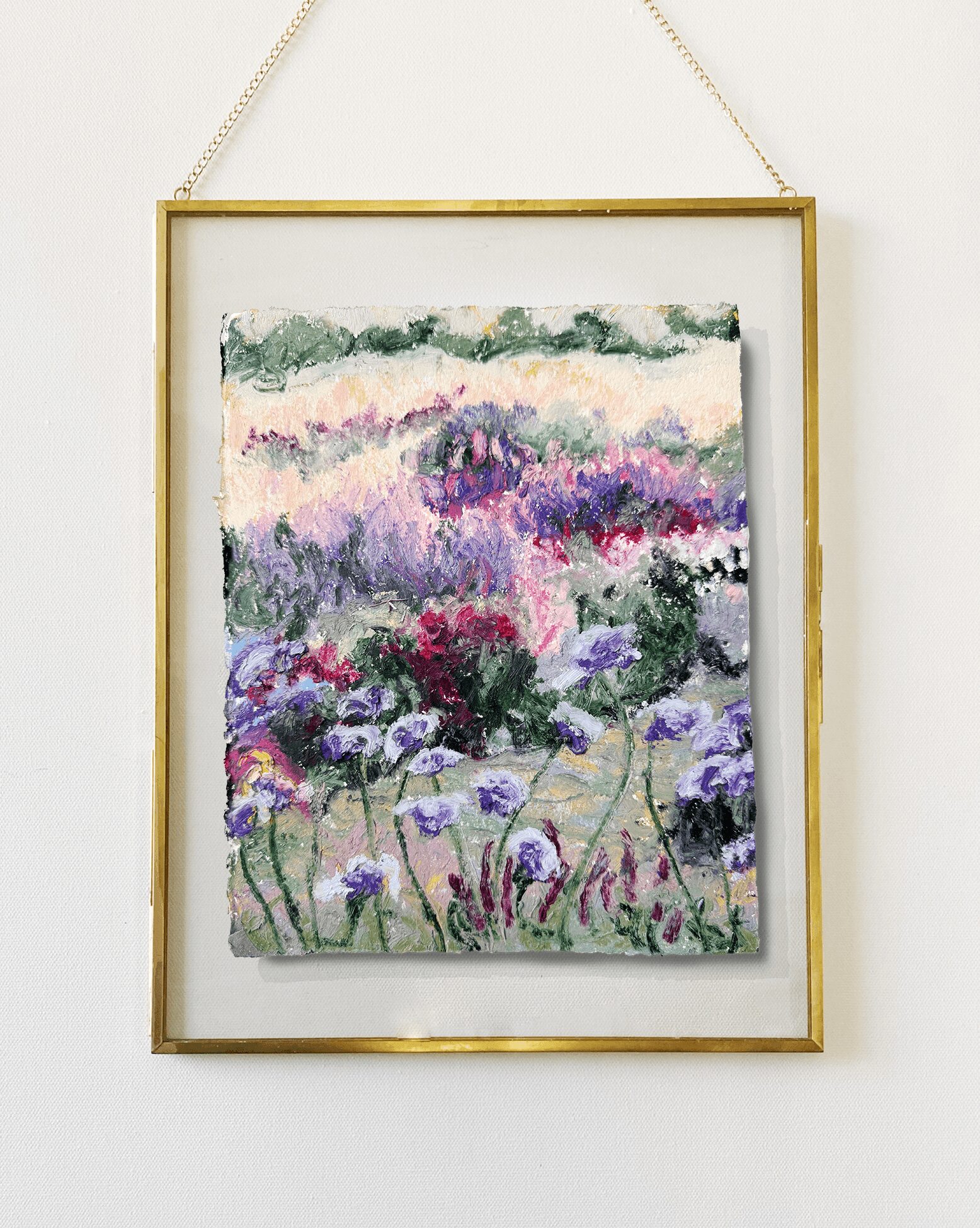 Framed painting of a colorful garden with purple, pink, and green flowers, hanging on a white wall.