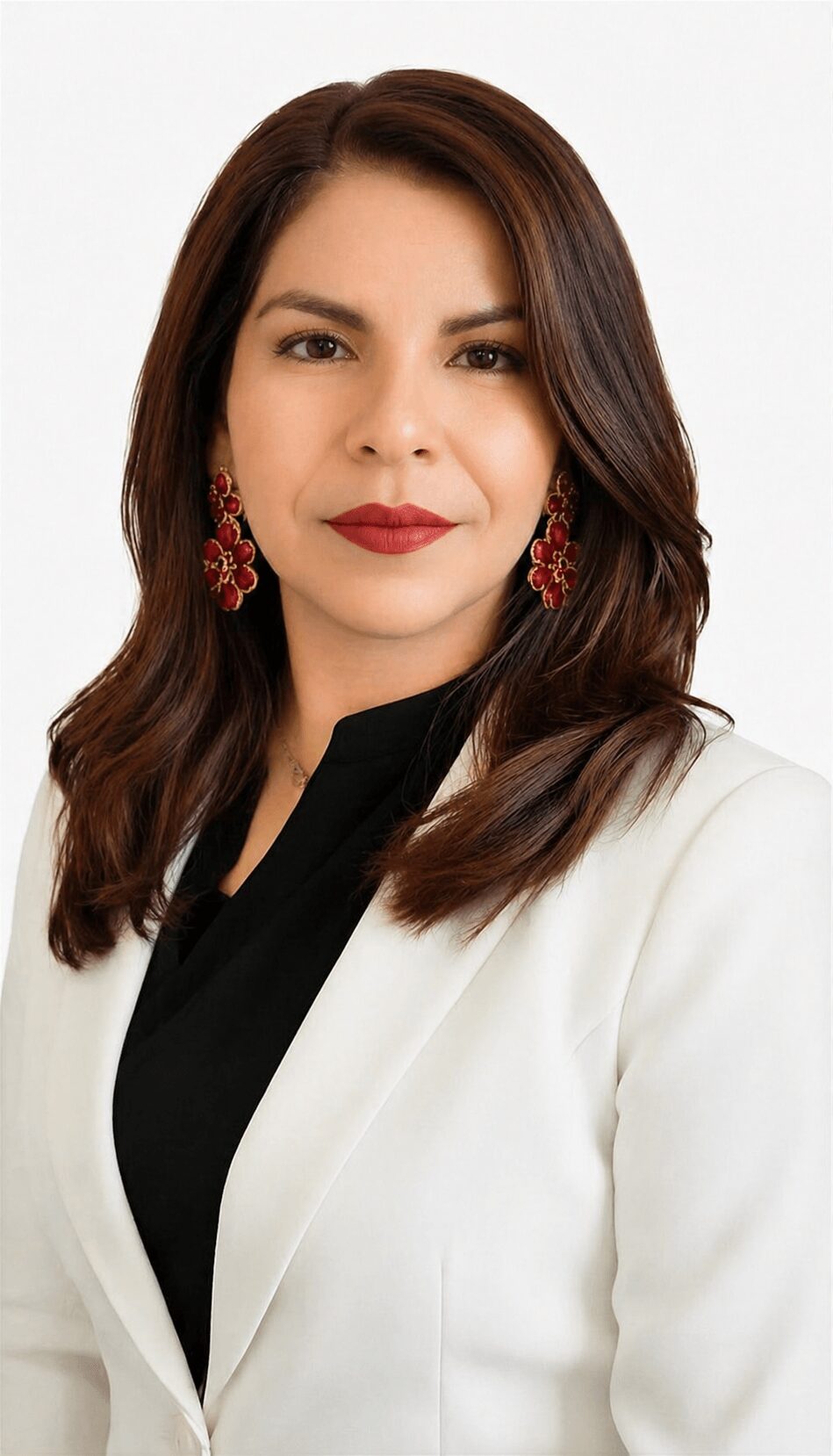 Woman with shoulder-length brown hair, red earrings, wearing a white blazer and black top, smiling slightly.