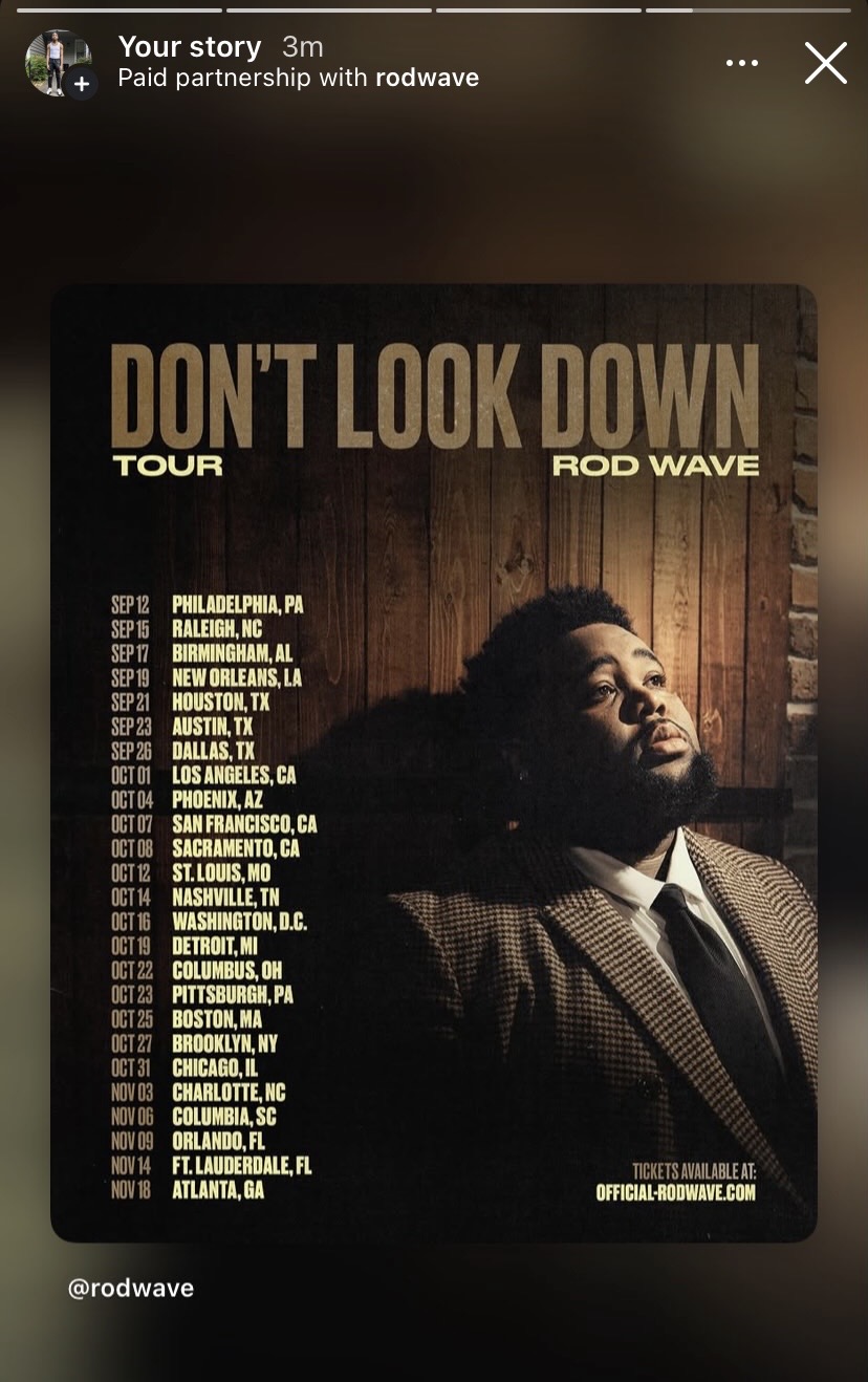 Concert poster for Rod Wave's 'Don't Look Down' tour featuring a man in a suit against a wooden background.