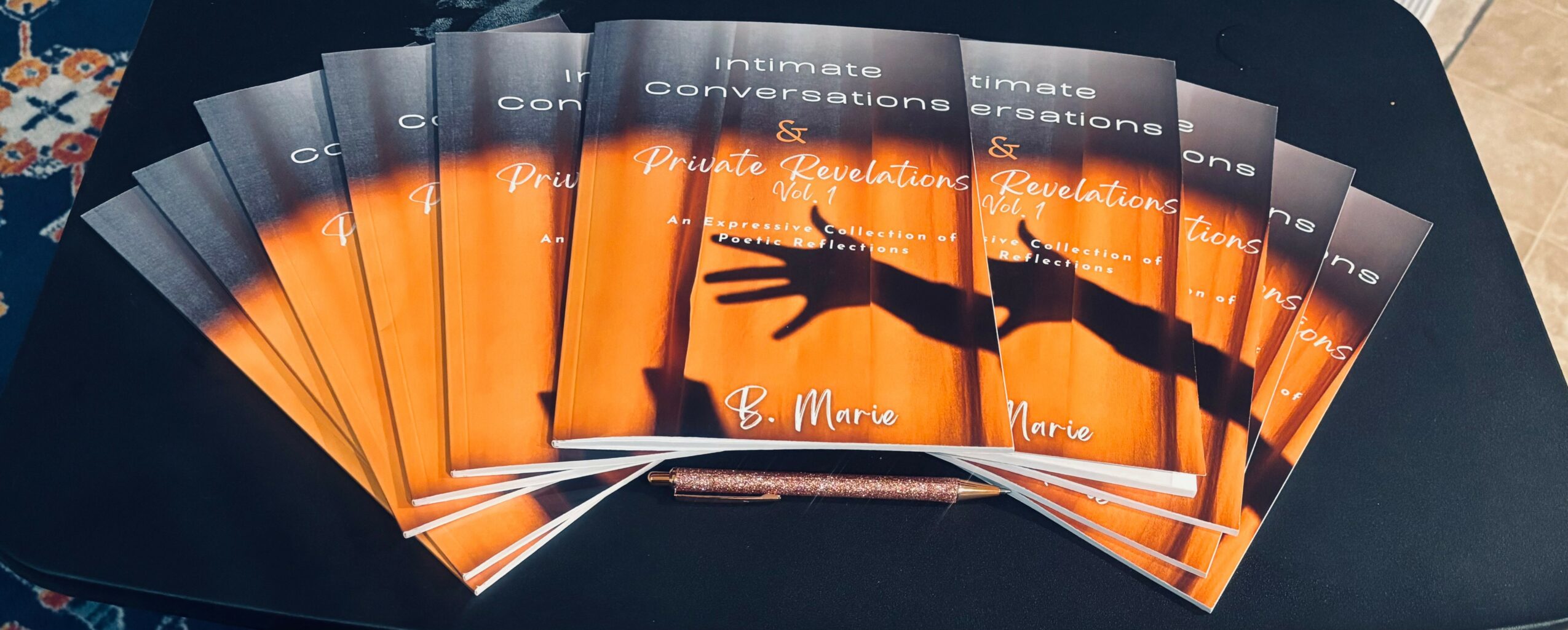 Stack of brochures with orange and black cover featuring a hand reaching out, text about conversations and investments.