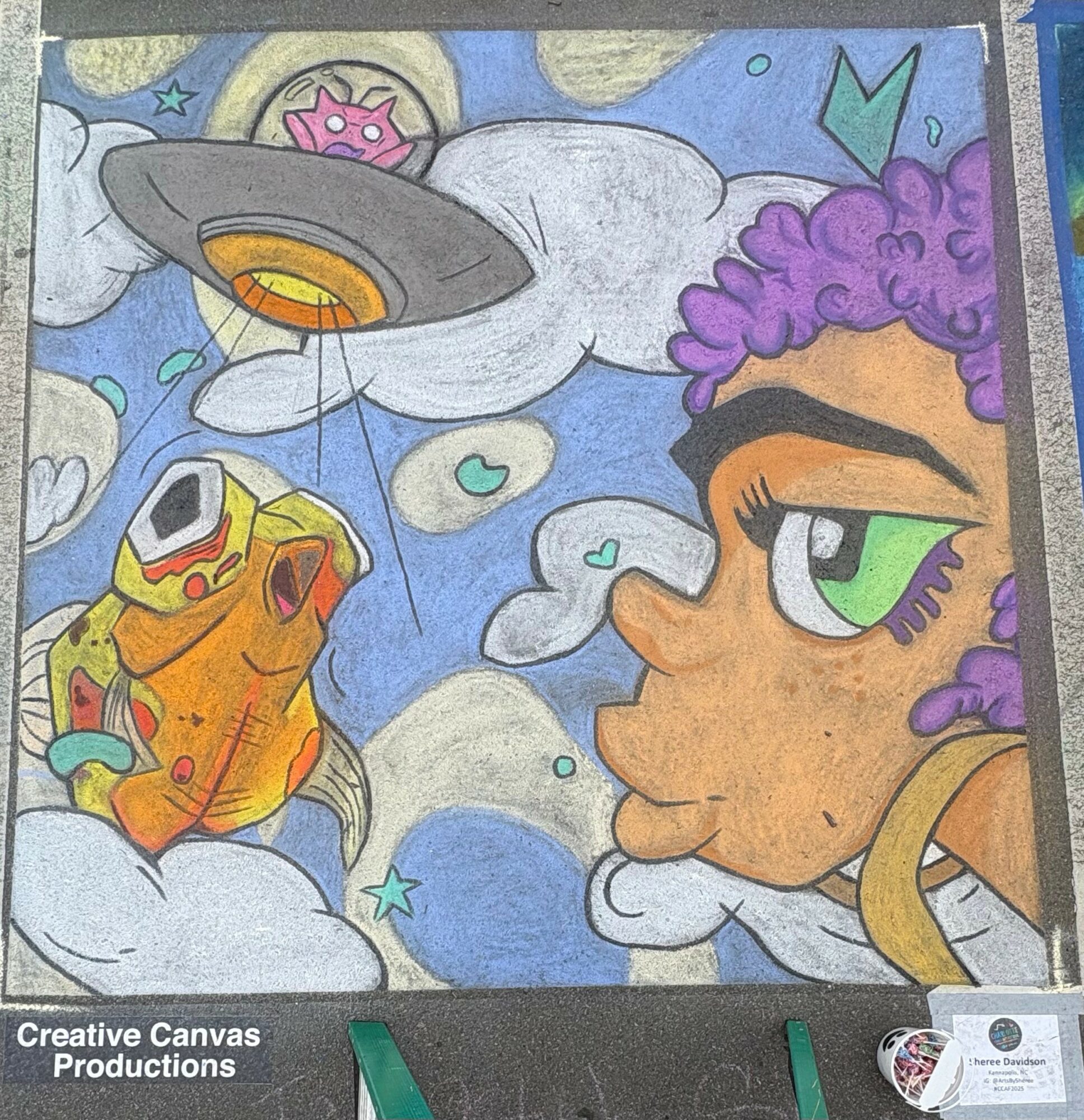 Colorful cartoon-style drawing of a girl with purple curly hair and green eyes, clouds, a UFO, and a fish in the sky.