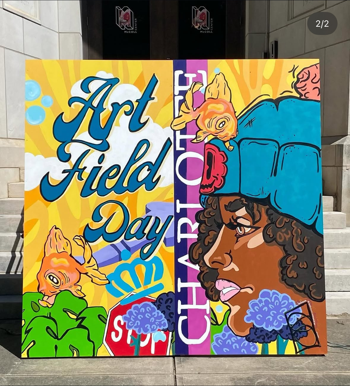 Colorful mural with text 'Art Field Day' and a woman with curly hair wearing a blue hat, surrounded by animals and abstract shapes.