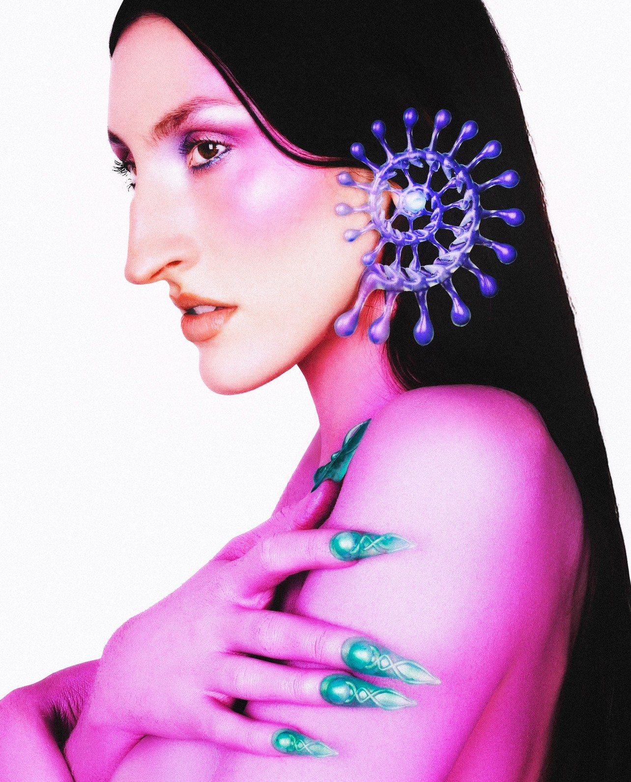 Woman with long black hair, pink makeup, and purple gloves, holding her shoulder with decorated nails, against a white background.