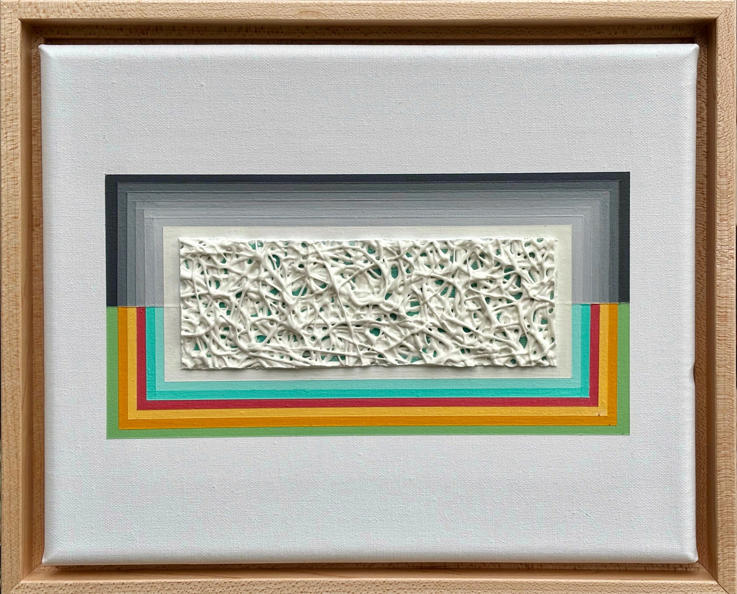 Framed artwork with layered colorful borders and a textured white rectangular piece in the center.