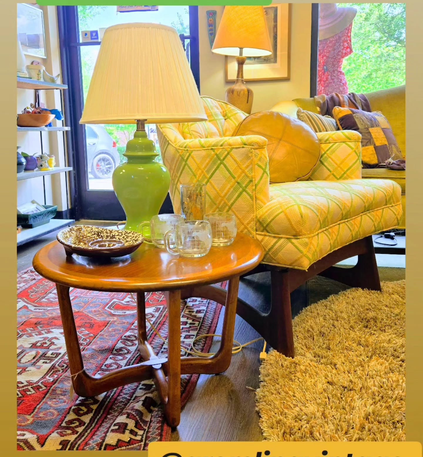Living room with yellow plaid sofa, green lamp, wooden side table, and colorful decor, viewed through glass door.