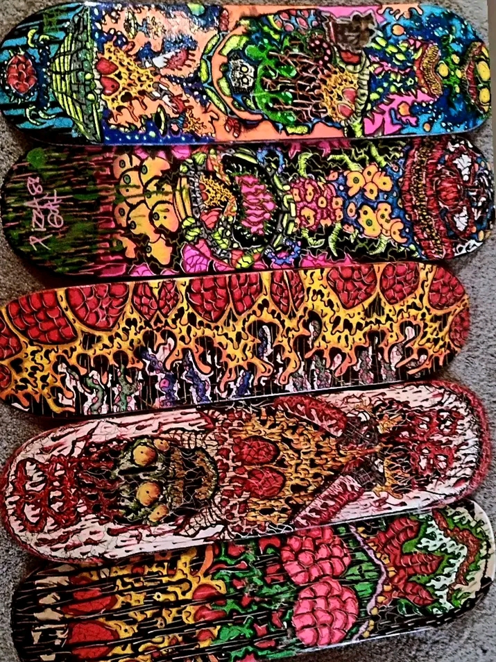 Five colorful fabric headbands with various intricate patterns stacked vertically.