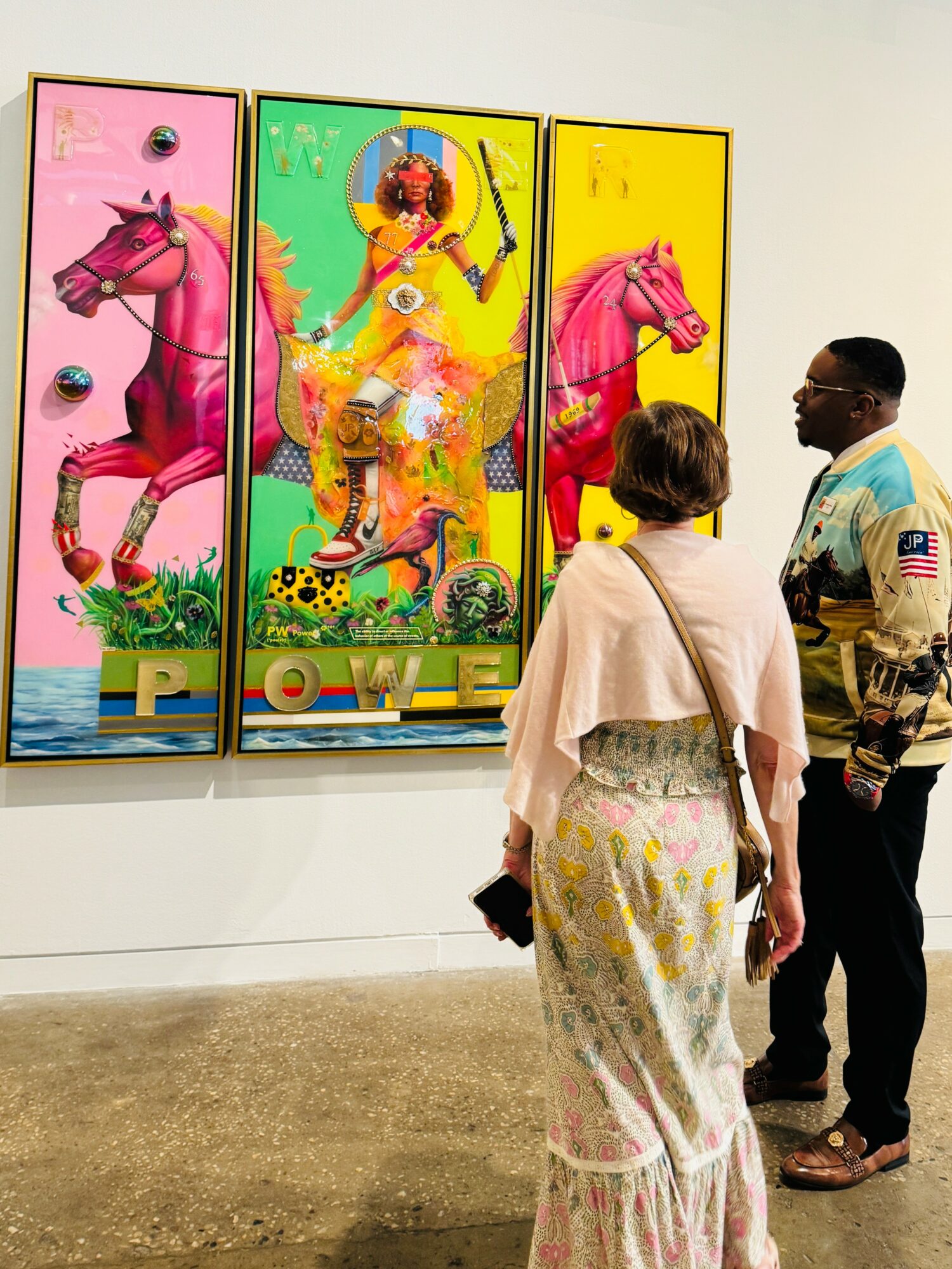 Three colorful art panels featuring pink horses and a person in vibrant clothing, with two viewers observing the artwork.