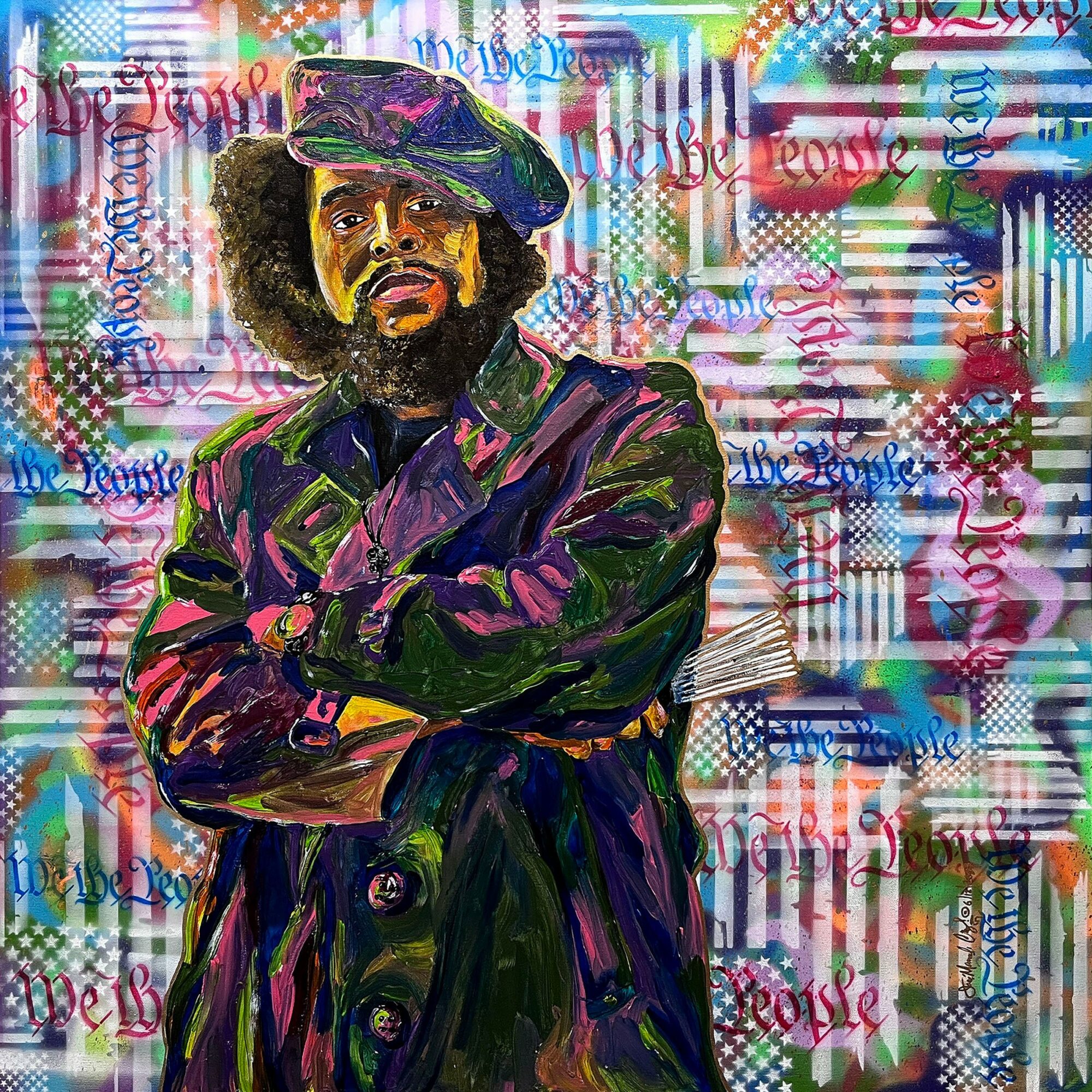 Portrait of a man with crossed arms, wearing a hat and coat, against a colorful, text-filled background.