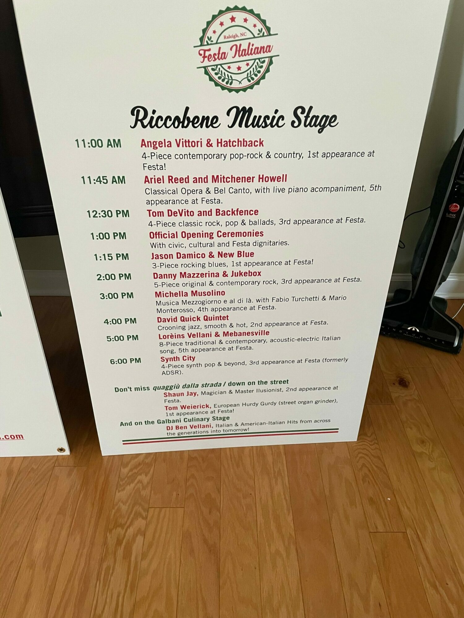 Menu with red and black text on white background, titled 'Ricohene Music Stage', with a logo at the top, placed on a wooden surface.