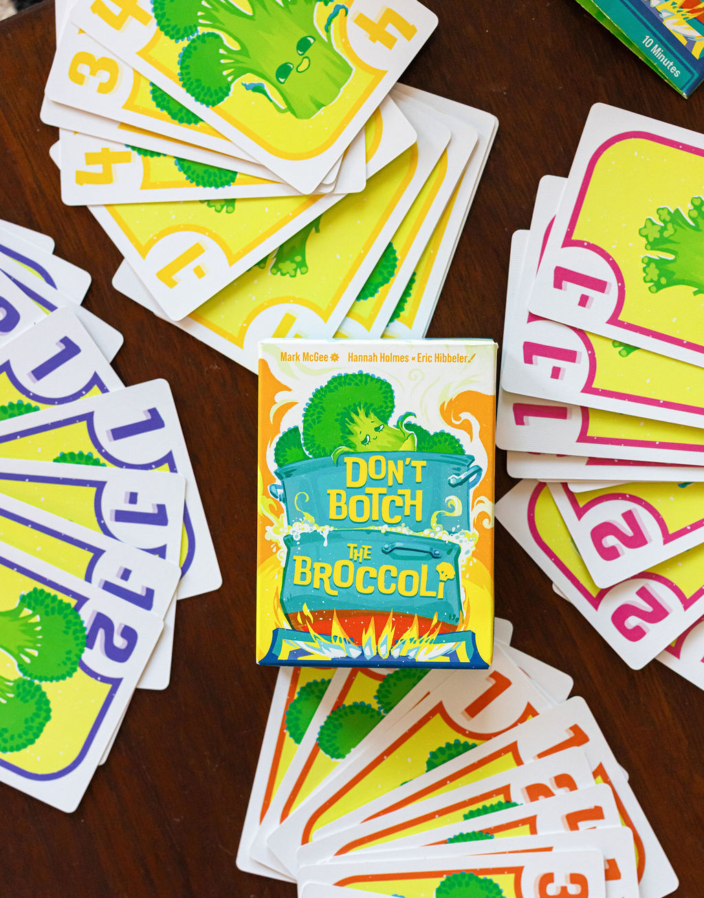 Stack of colorful cards with broccoli illustrations and the phrase 