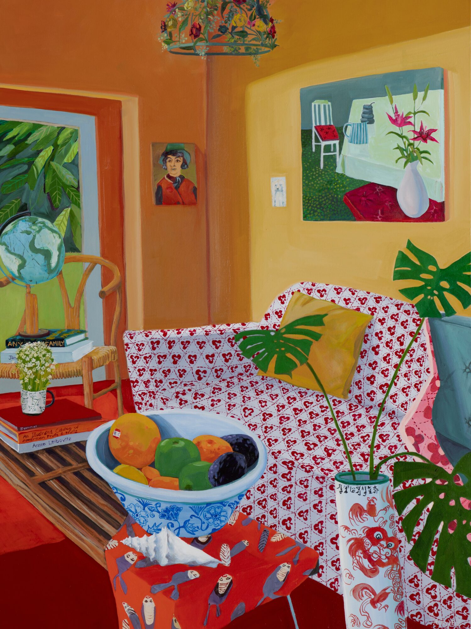 Living room with colorful walls, paintings, a patterned sofa with cushions, a bowl of fruit, and plants.