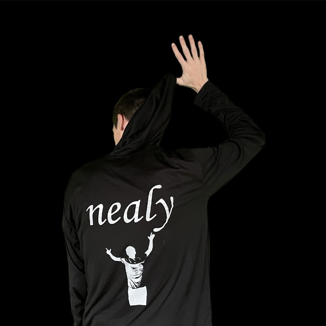Person wearing a black jacket with a graphic of a person raising arms and the word 'nealy' on the back, facing away, black background.