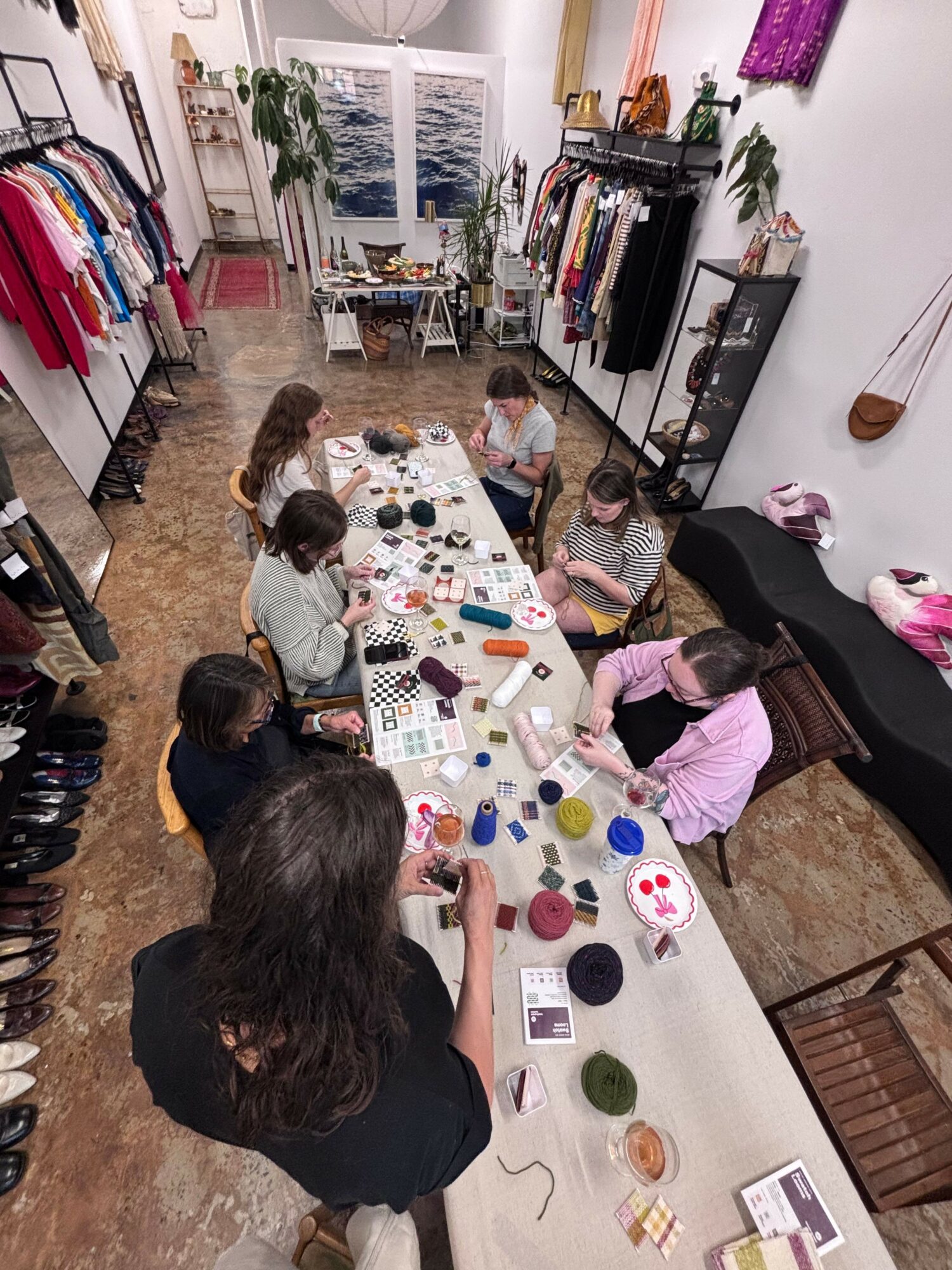 People gathered around a table engaging in arts and crafts activities in a decorated room.