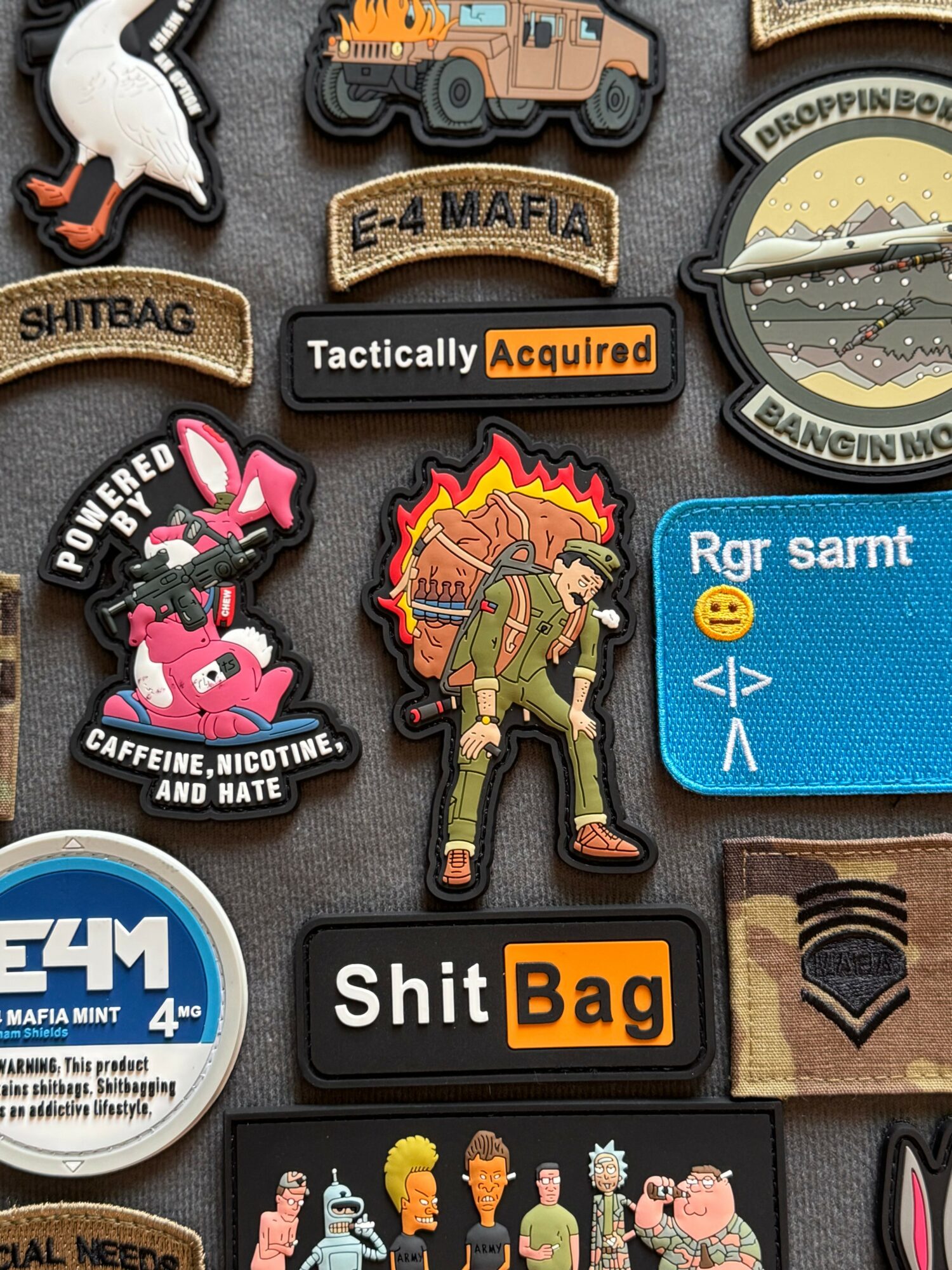 Collection of patches and badges with various designs, including vehicles, characters, and text, arranged on a surface.