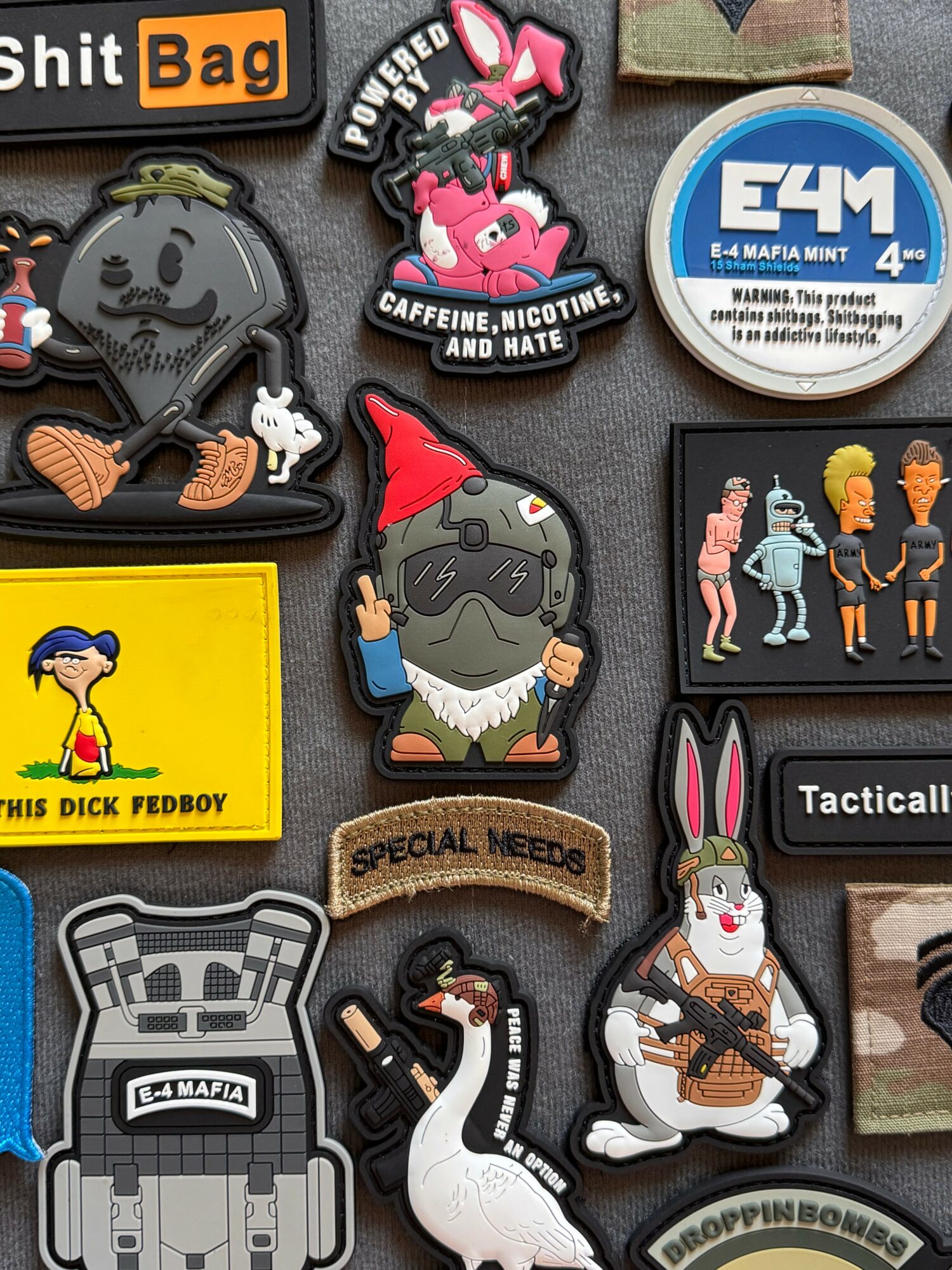 Collection of colorful stickers and patches with various characters, logos, and designs on a dark background.