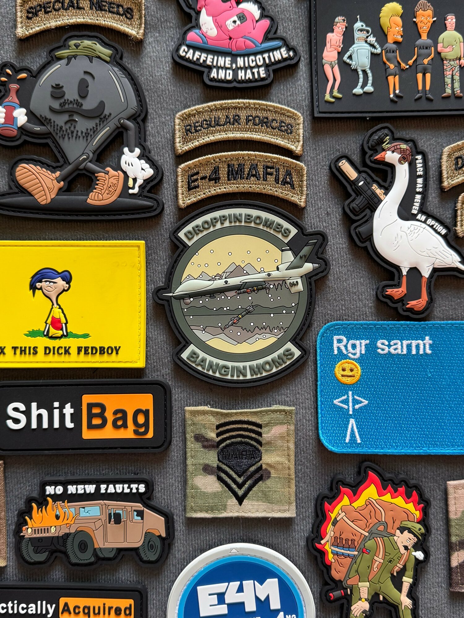 Collection of patches and stickers including a dog with guitar, swan, cartoon character, and text-based designs.