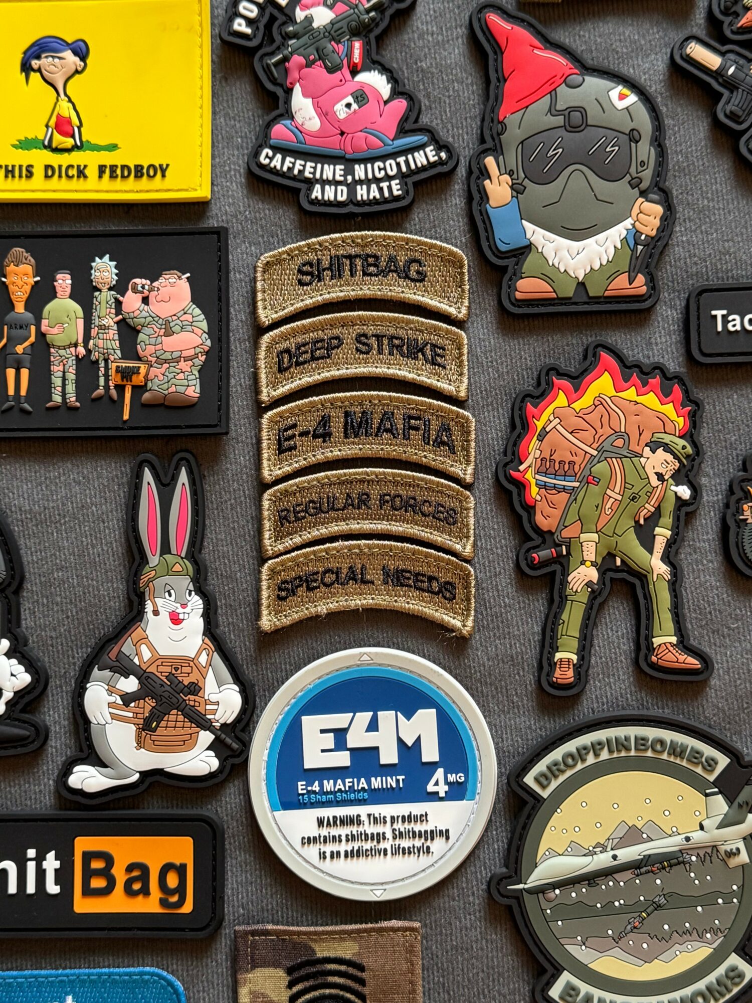 Collection of colorful patches and pins with various designs, including characters, text, and symbols, arranged on a dark background.