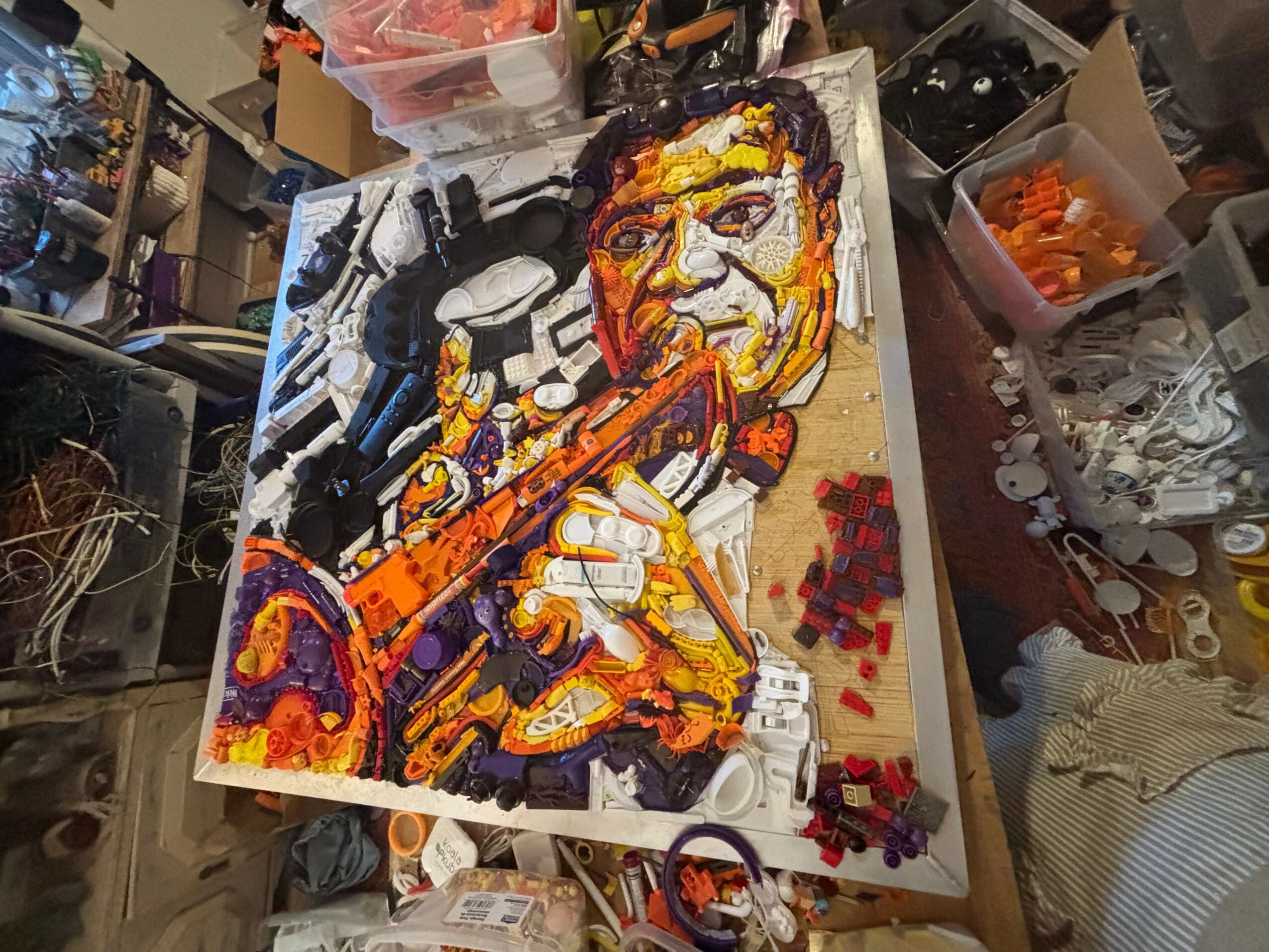 Colorful painting of a person playing a flute, with various art supplies and tools around the workspace.