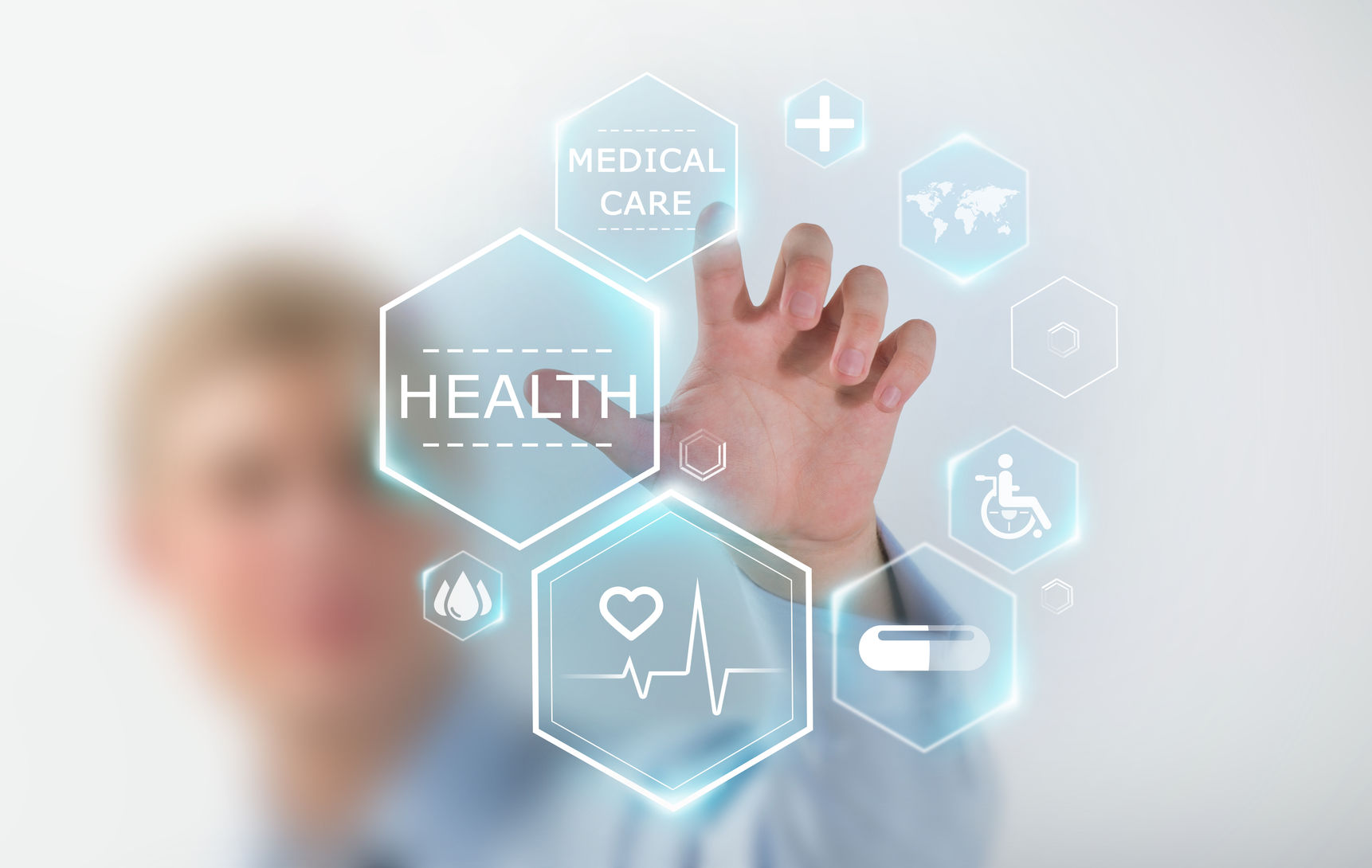 Person interacts with digital health icons, including medical care, health, and accessibility symbols, on a transparent screen.
