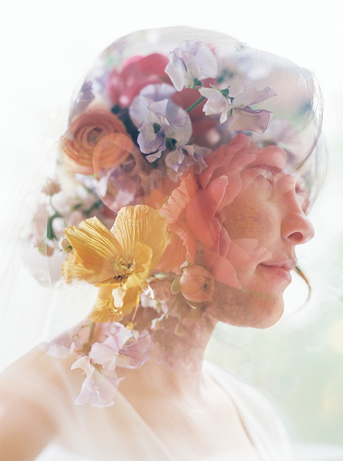 Profile of a woman with a floral headdress, blending flowers and her face, against a light background.