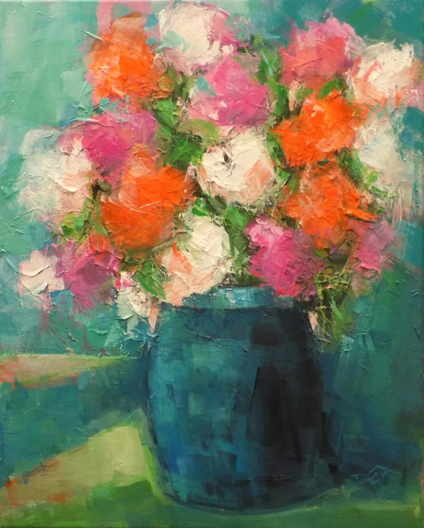 A colorful bouquet of flowers in a blue vase on a table, with a green background.