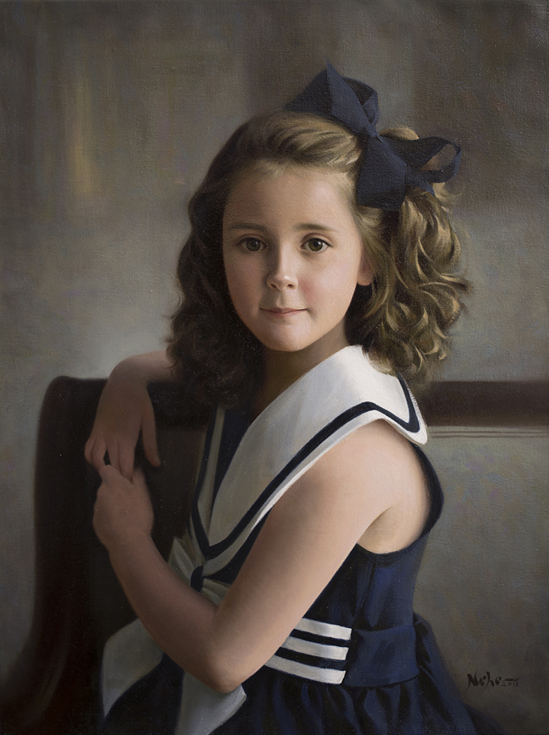 Young girl with curly hair and a large bow, wearing a navy and white sailor dress, sitting on a chair.