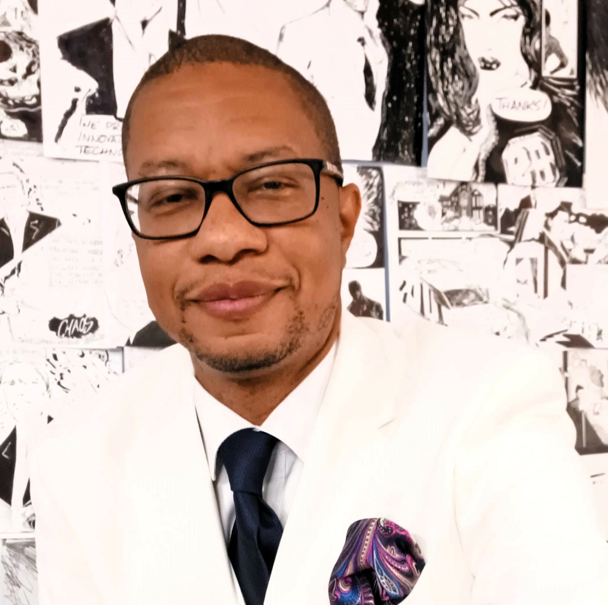 Man wearing glasses, white shirt, and tie, smiling in front of a collage of black-and-white images.