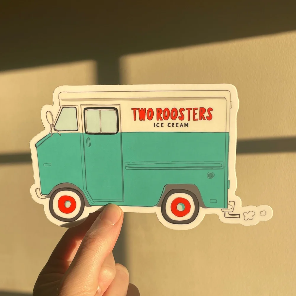 Sticker of a teal ice cream truck with red and white wheels, labeled 